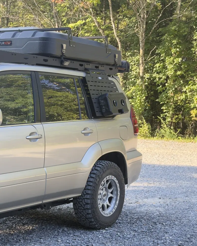 Ginny parked on gravel at the edge of the woods